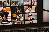 A community of creators in a virtual meeting. You see 9 boxes with individual faces on a laptop screen.