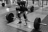 A woman (me!) about to lift a barbell