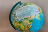 A globe “wearing” a face mask against covid19