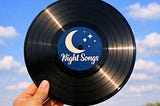 The AI-generated image shows a closeup of a hand holding up a vinyl album while outside. The sky is a beautiful shade of blue and there are multiple clouds. On the label of the record is a drawing of a C-moon with stars and planets in the distance. Also shown is the title of the record: Night Songs.
