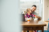 Dad and toddler at table.