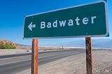 Photo of the Badwater Basin turnoff sign near Furnace Creek, CA, in Death Valley National Park. The dry lake bed is eight miles long by five miles wide and at 282 feet below sea level, is the lowest point in North America. (Photo: ©Craig K. Collins)