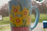 Ceramic coffee tumbler with hand-painted daffodils that I got at the thrift store.