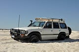 An Ute bogged down in soft beach sand