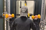Older woman doing bicep curls in the Fitness Center