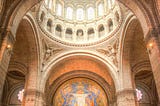 An interior view of a quincunx design, with the central dome and four smaller domes in the corners, plus a semidome over the apse. Credit to Skitterphoto on Pexels.