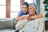 home health aide hugging her client