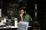 A guy working and looking very confused.