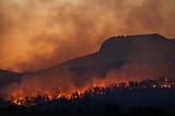 silhouette of mountains and wildfire.