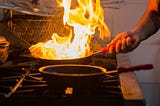 Flaming saute pan in an industrial kitchen