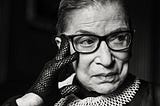 Black and White image of Ruth Bade Ginsburg wearing one of her signature collars