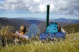 Author looking off to the horizon with his pack next to him.