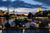 A view of the Limmat River at nighttime.