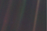 The famous picture of Earth taken by Voyager 1 in 1990, in which the Earth is just a single blue pixel, appearing like a mote of dust suspended in a sunbeam, as Carl Sagan so nicely reflected.