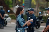 Kendall Jenner giving policeman a Pepsi