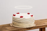 A decorated cake with a halo over it.