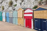 Beach huts in different colourings, but with the same shape