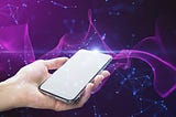 Close up of female hand holding white mock up cellphone with creative glowing purple metaverse space background. Abstract world and innovation concept