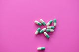 Image of pills on a pink background