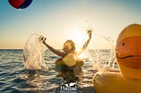 Happy person floating on a water float in summer