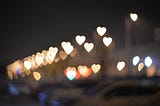 Beautiful image of hearts lit up against a black background.