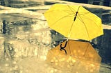 A yellow umbrella on an empty street — already a powerful image.
