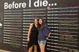 the author and her friend Megan stand in front of a college dream board