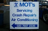 Garage sign containing inappropriate apostrophes.