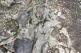 What we are looking at: Rock formation on a path of a sloped hill.