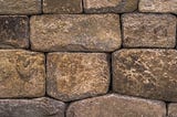 Photo of uneven blocks making a stone wall