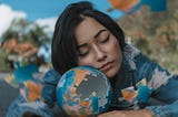 Woman in Blue and White Floral Long Sleeve Shirt Holding A Round Shaped Puzzle and sleeping.