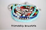 picture of a pile of colorful friendship bracelets made by children