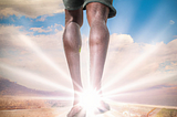 Two legs of a man on the front, with rays of sunlight emanating from between them