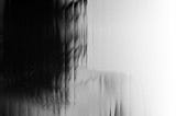 A woman’s image distorted behind a screen