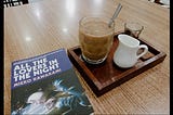 enjoying a glass of coffee while reading a novel in a well-known cafe in Semarang