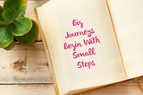 Open notebook with inspirational quote: Big Journeys Begin With Small Steps, symbolizing the start of a developer’s journey.