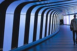 Two men walking down a corridor