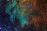 Humbling Celestial Vastness — The Pelican Nebula. A mesmerizing deep-space view of the Pelican Nebula, displaying a vibrant interplay of glowing gas clouds in shades of teal, orange, and dark interstellar dust amidst dots of countless stars.