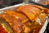 Freshly finished dry rubbed pork ribs still in the pan and steaming