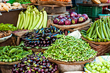 Photo of a vegetable shop in India selling Okra, Egg Plants etc.