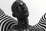 A person’s head and neck covered in a smooth black and white swirl design.