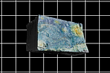 a large limestone block floats above a black background with a white grid. Van Gogh’s ‘The Starry Night’ is projected on the front.