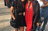 Josefina Mancilla, a Latina, in her college graduation cap and gown, embracing her sister for a picture.