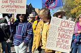 Two young men marching in the No Kings protest in Santa Fe, NM. No Ice. No Ice. Soldarity.