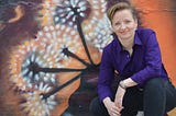 Diane Whiddon in front of dandelion graffiti