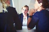 woman in between two other women listening intently