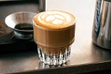 latte art in cortado cup. Espresso for grinding on startup.