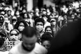 A Black man in a mask protesting in a crowd in Charlottsville after George Floyd’s death.