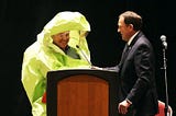 State Senator appears in Hazmat suit to announce that “Everything is Fine”