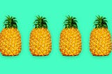 4 pineapples in a line with a teal background